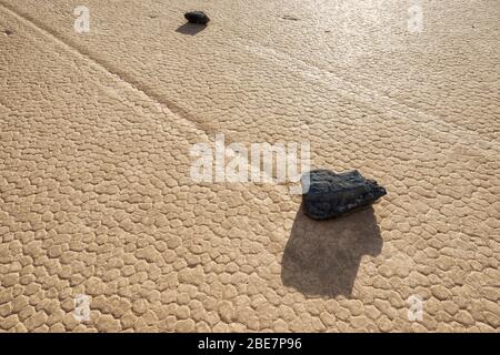 Moving rocks leave trails on the Racetrack Playa in Death Valley National Park, California, USA. Stock Photo