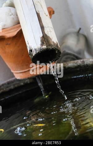 Water pouring from bamboo tube to below, Equipment for water in the garden Stock Photo
