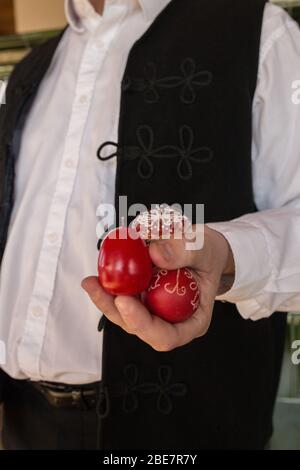 Man holding hand-painted traditional Easter eggs during a traditional Easter celebration in rural Hungary Stock Photo