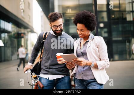 Business people discussing and smiling while walking together outdoor Stock Photo