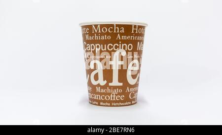 Coffee in disposable cup with inscriptions. Isolated on white. Stock Photo