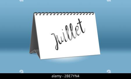 A calendar for the desk shows the French month of Juillet (July in English language) Stock Photo