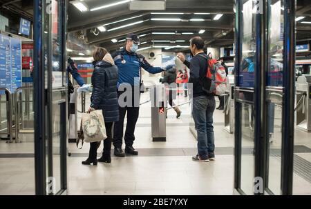 Spain - Madrid - 13 April, 2020 - Coronavirus Crisis - Face masks are distributed by police and state security forces at public transport stations - After the last measures adopted by government, Spain opens the economic activity to some sectors such as construction. Stock Photo