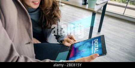 digital transformation concept,asian business woman learning from tablet about digitization transform analog to digital in business. Stock Photo