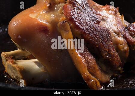 Roasted pork shank, pork knee. Cooking of traditional Croatian meal Peka in metal pots called sac, sach or sache. Stock Photo