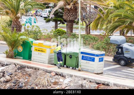 Jetwashing the bins with a disinfectant spray during the coronavirus pandemic in Playa San Juan, Tenerife, Canary Islands, Spain Stock Photo