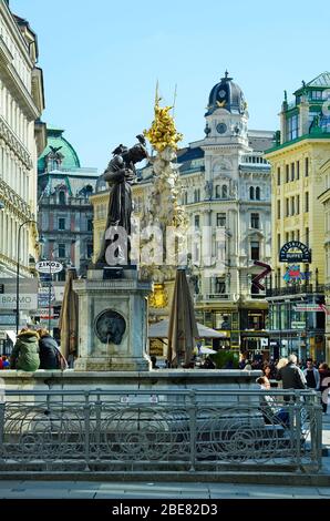 Vienna, Austria - April 24th 2011: unidentified people on pedestrian precinct Graben with lions fountain aka Saint Florian and plague column in the in Stock Photo