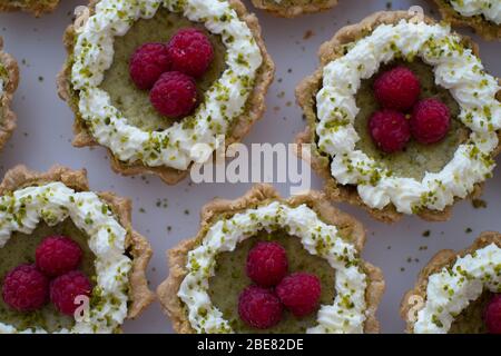 Raspberry and pistachio frangipane tarts, made by Scotland-based artisan baker Louise Paterson Stock Photo