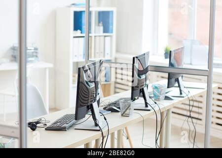 Background image of empty office interior with three computers on desks in row, copy space Stock Photo