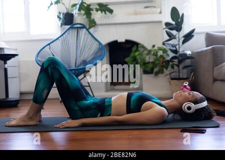Caucasian woman stretching at home during coronavirus Covid19 pandemic Stock Photo