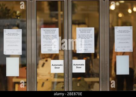 Pictured: Coronavirus information of the front door of the Marks and Spencer store in Neath, Wales, UK. Friday 27 March 2020 Re: Covid-19 Coronavirus Stock Photo