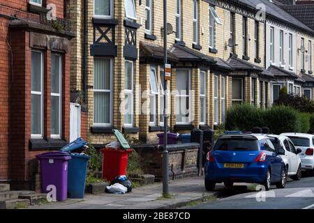 Liverpool City Council wheelie bins outside, overflowing, waiting for collection on a residential suburban street  Liverpool, Merseyside, England. Stock Photo