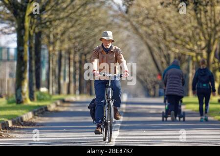 Pictured: A man cycles on the seaside path in Swansea, Wales, UK. Friday 27 March 2020 Re: Covid-19 Coronavirus pandemic, UK. Stock Photo