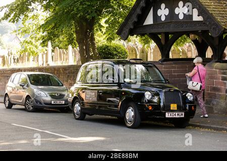 Black Taxi Tour parked in front of St Peters Church in Woolton Village Liverpool, where John Lennon and Paul McCartney first played together Stock Photo
