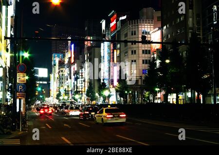 Night time Street scene showing the neon lighting of the Shinjuku district of Tokyo, Japan Stock Photo