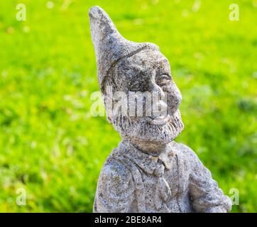 Stone Garden Gnome on the Lawn Stock Photo