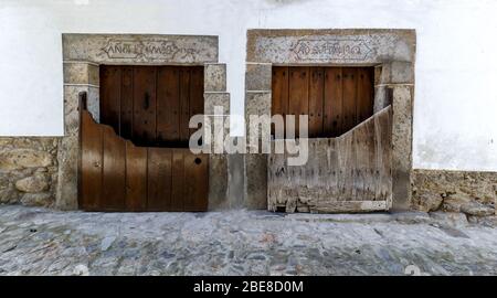 Popular architecture in Candelario. Spain.  View of entrance of the houses with its “Batipuerta”, half door made of wood Stock Photo