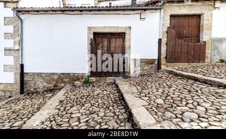 Popular architecture in Candelario. Spain.  View of entrance of the houses with its “Batipuerta”, half door made of wood Stock Photo