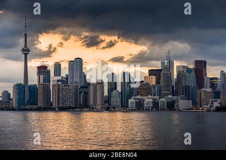 Toronto skyline buildings in the background, with the sea in the foreground, on a cloudy sunset. Toronto, Ontario, Canada Stock Photo