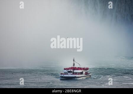 Detail of tourist boat in the waterfall on the Canadian side at sunset Concept of nature and travel Niagara Falls, Canada United States of America Stock Photo