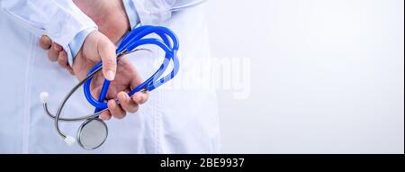 Female doctor portrait, young woman physican holding a stethoscope isolated on white background, close up, cropped view, copy space Stock Photo