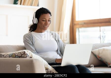 African american girl in headphones work at laptop Stock Photo