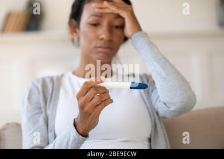 Sad african american girl hold pregnancy test Stock Photo