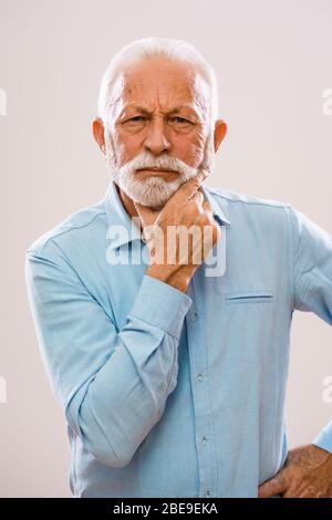 Portrait of pensive and serious senior man. Stock Photo