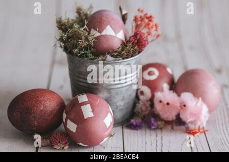 Rose colored Easter egg composition. Rustic background. Stock Photo