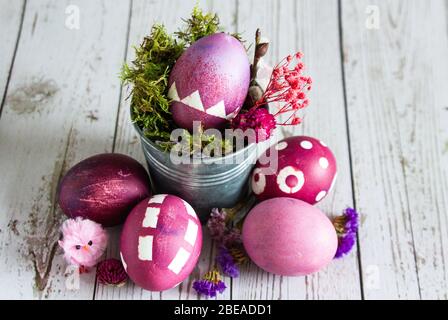 Rose colored Easter egg composition. Rustic background. Stock Photo