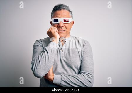 Middle age handsome grey-haired man using 3d glasses over isolated white background looking stressed and nervous with hands on mouth biting nails. Anx Stock Photo