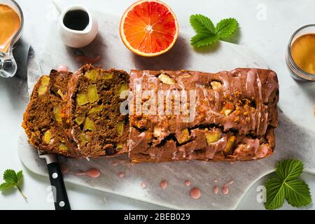 apple homemade vegan loaf cake with icing and espresso coffee. healthy morning breakfast or snack Stock Photo