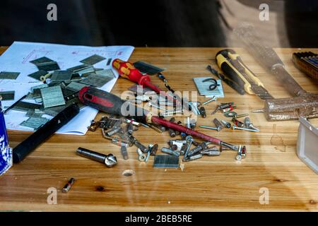 desktop in the workshop, tools lie on the table in the workshop. workshop table behind glass Stock Photo