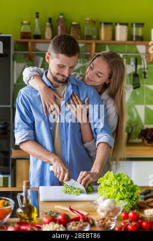 Happy couple preparing healthy vegetarian meal together Stock Photo