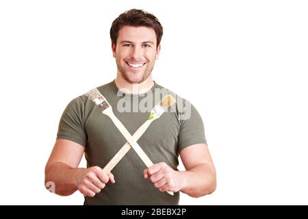 Painter holds two brushes crossed Stock Photo