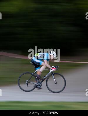 Pan blur of a cyclist in action whilst competing in a Criterium Race at Crystal Palace Park. Stock Photo