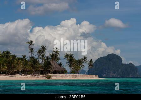 Beautiful tropic island traditional bungalow blue lagoon sand beach Stock Photo