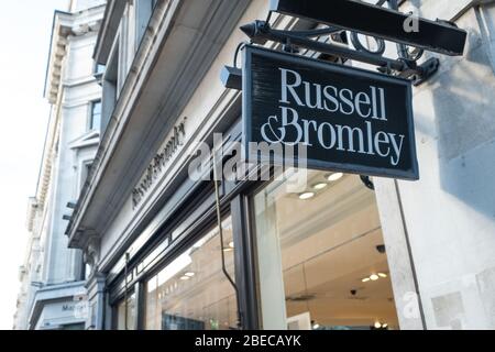 LONDON- APRIL, 2019: Russell & Bromley store exterior sign on Regent Street. An old British shoes and handbag retailer Stock Photo