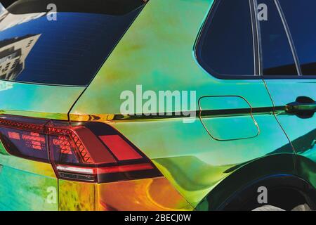 Chameleon holographic colour car. Side view closeup. Beautiful modern LED backlights. Car wrapping. Car exhibition. Stock Photo