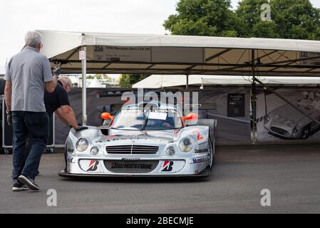 The No.2 Mercedes-AMG CLK GTR  race car being manually wheeled in to place at the Goodwood Festival of Speed car show. Stock Photo