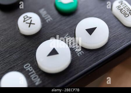 A close up portrait of the volume up and down buttons on a radio, television or surround sound system, used to alter the sound level. In the backgroun Stock Photo