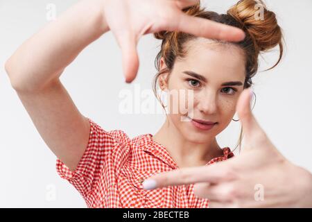 Close up of a lovely cheerful young teenage girl wearing summer clothes standing isolated over gray background Stock Photo