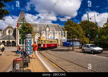Christchurch tram just leaving from the stop in front of the gothic architecture Canterbury Museum. Christchurch, New Zealand. Stock Photo
