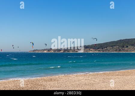 Tarifa, Spain. 3rd February, 2020. Many kitesurfers doing sports in the Atlantic ocean near the windy Bolonia beach Stock Photo