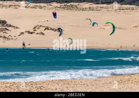 Tarifa, Spain. 3rd February, 2020. Many kitesurfers doing sports in the Atlantic ocean near the windy Bolonia beach Stock Photo