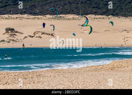 Tarifa, Spain. 3rd February, 2020. Many kitesurfers doing sports in the Atlantic ocean near the windy Bolonia beach Stock Photo