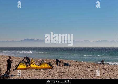 Tarifa, Spain. 3rd February, 2020.  Kitesurfers preparing to go to the water near the windy Bolonia beach Stock Photo