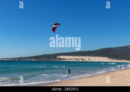 Tarifa, Spain. 3rd February, 2020. Many kitesurfers doing sports in the Atlantic ocean near the windy Bolonia beach Stock Photo