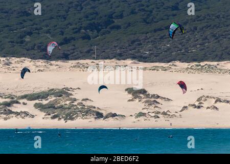 Tarifa, Spain. 3rd February, 2020. Many kitesurfers doing sports in the Atlantic ocean near the windy Bolonia beach Stock Photo