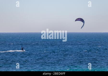 Tarifa, Spain. 3rd February, 2020.  Kitesurfer in the Atlantic ocean near the windy Bolonia beach Stock Photo